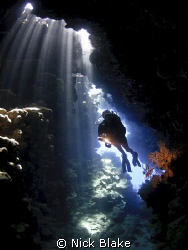 Diver in the caves at Jackfish Alley, Red Sea by Nick Blake 